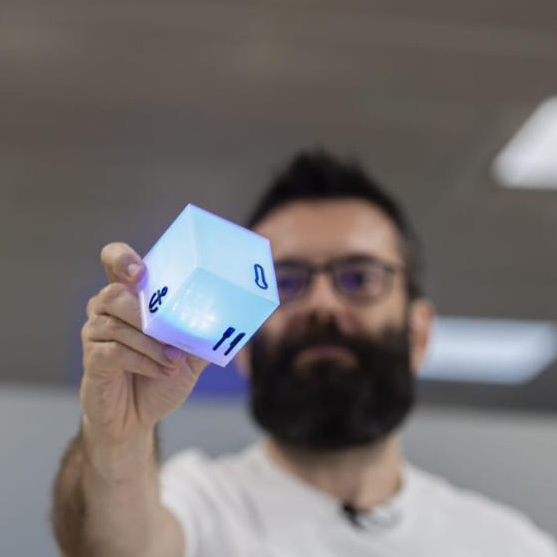 Juan sujetando un cubo luminoso